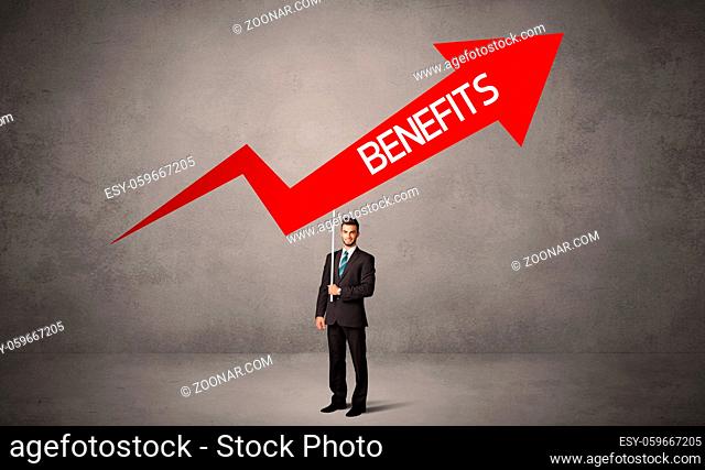 Young business person in casual holding road sign with BENEFITS inscription, business direction concept