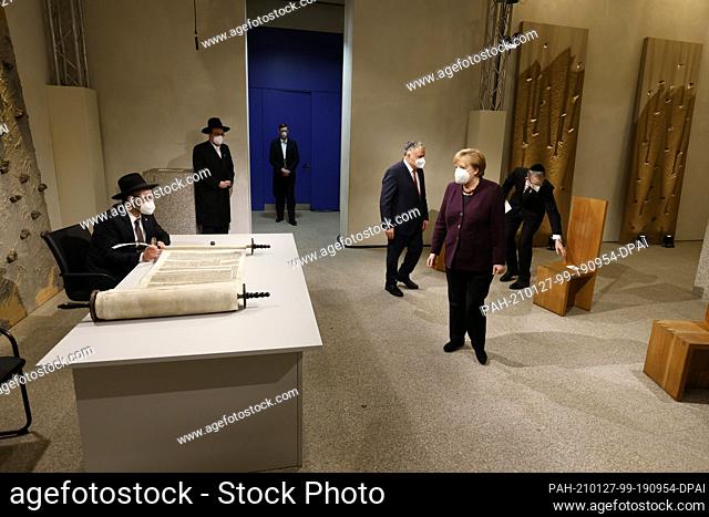 27 January 2021, Berlin: Rabbi Shaul Nekrich (front, r) sits at a table as German Chancellor Angela Merkel (CDU, front) arrives for a ceremony to complete the...