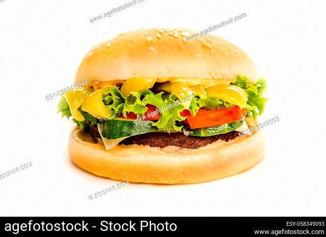 fast food set of big hamburger and fries on a light background. Food is unhealthy. Hamburger on a white background. Close-up