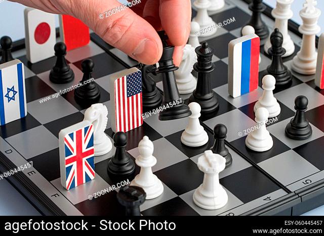 Politician's hand moves a chess piece. Conceptual photo of a political game and strategy