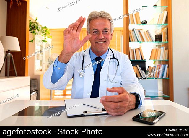 Portrait of senior caucasian male doctor in office