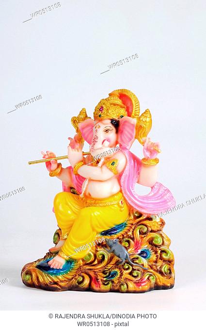 Statue of lord ganesh playing flute , India