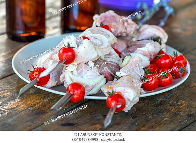 close-up appetizing meat shish kebab lying on a table, raw meat
