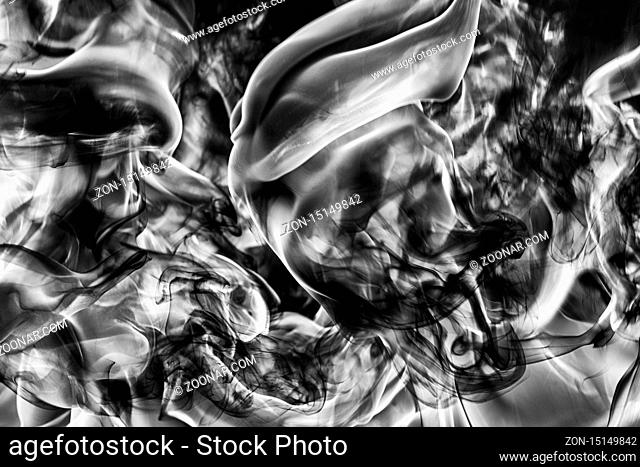 Abstract plume of natural black smoke and white huge flame of strong fire, motion blur from fire, high temperature flames