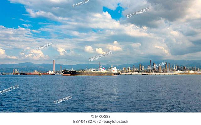 View of big ships in industrial zone in Milazzo on Sicily, Italy