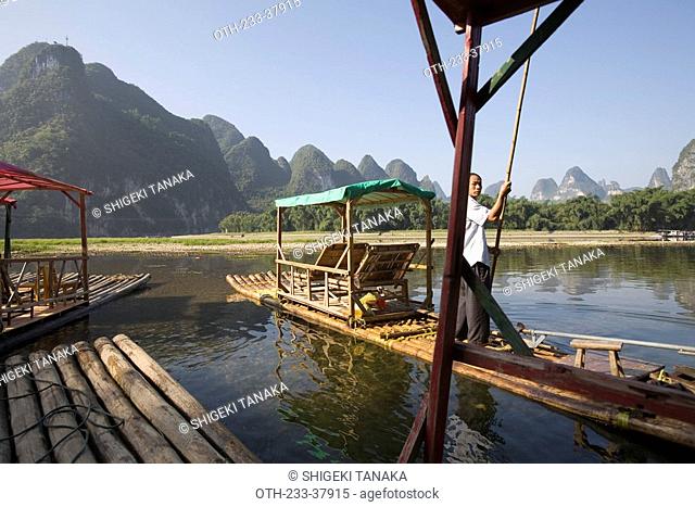 A boatman rafting the bamboo raft on Li River Lijiang, Xingping, Guilin, China