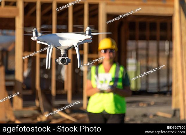 Female pilot flies drone quadcopter inspecting construction site
