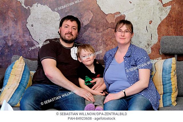 Claudia Menschel, her husband Sven and their three-year-old son Tobias sitting on the coach in their apartment in Leipzig, Germany, 19 October 2016