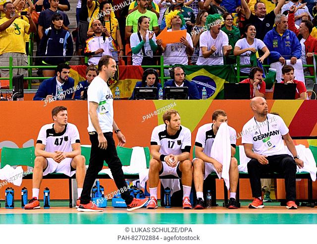 Assistant coach Axel Kromer (R) and head coach Dagur Sigurdsson (2-L) of Germany react during the Men's Preliminary Group B match between Brazil and Germany of...