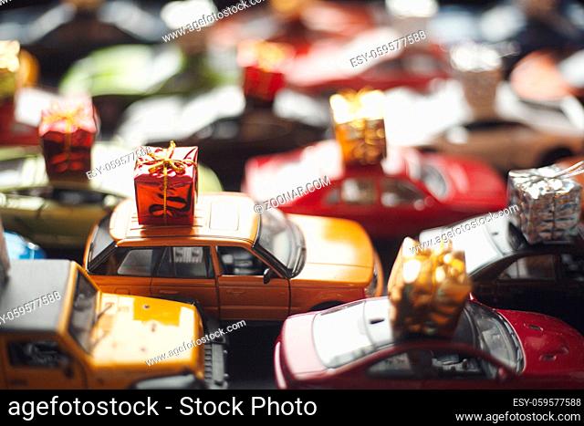 Traffic jam of toy cars carrying holiday gifts or black friday sale purchase
