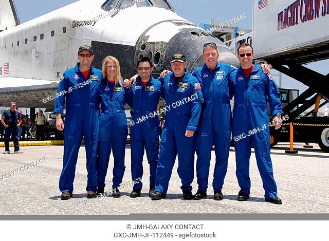 The STS-124 mission crew pose for a group photo before heading to crew quarters after their successful landing aboard Space Shuttle Discovery on runway 15 at...