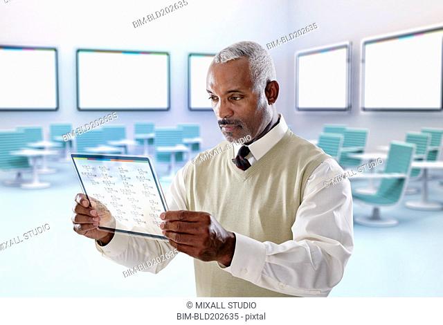 Black businessman using digital tablet in conference room
