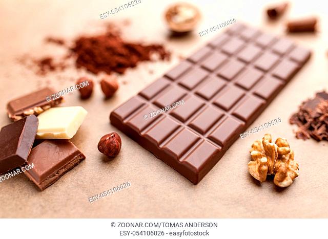 Delicious sweet chocolate bar and ingredients