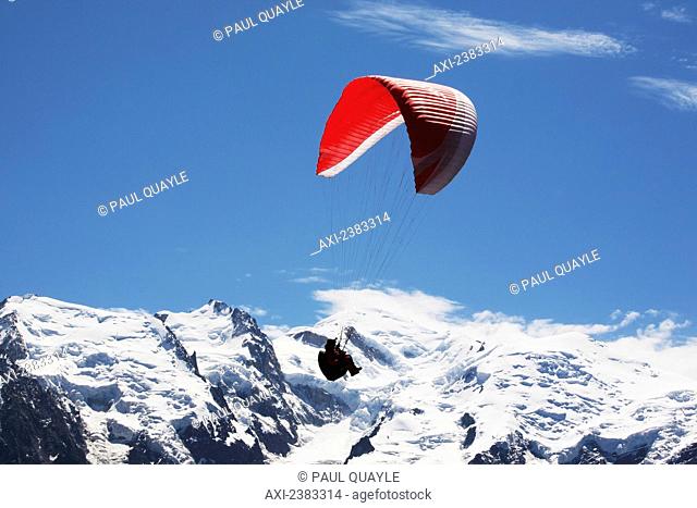 Paraglider above Chamonix-Mont Blanc valley, with Mont Blanc massif mountain range in the background; France
