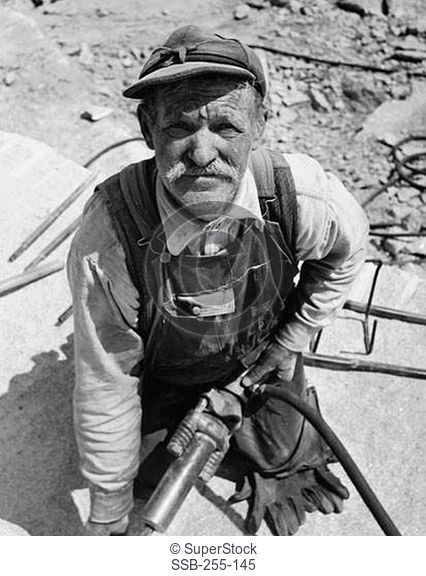 Miner holding a jackhammer