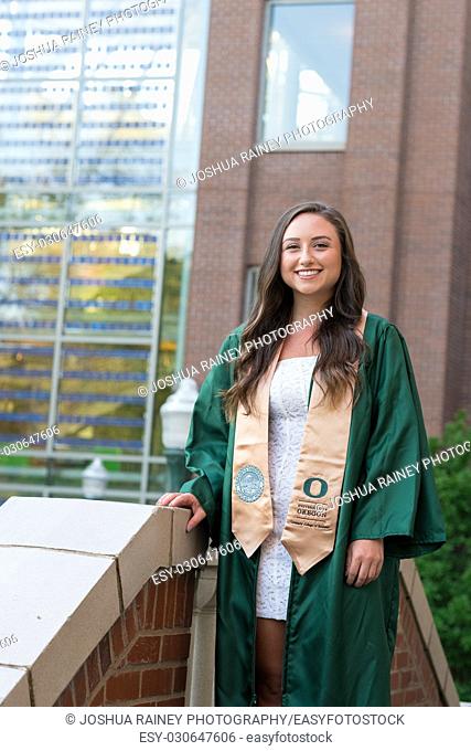 EUGENE, OR - MAY 22, 2017: Female college grad in the Lillis business plaza for graduation photos on campus at the University of Oregon in Eugene