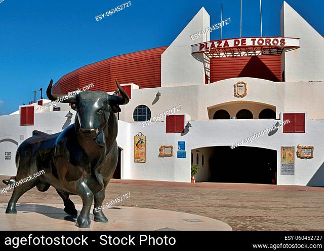 Ein Bronze Stier in moderner Form vor der historischen Stierkampfarena in Roquetas