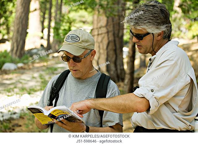 CALIFORNIA   South Lake Tahoe   Two middle aged men consult trail guide on Rubicon Trail