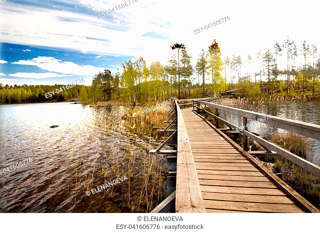 Wooden pier on beautiful lake in the national park Repovesi, Finland, South Karelia