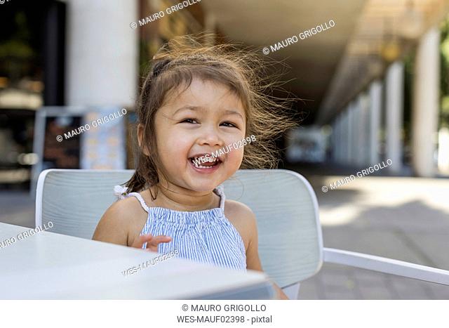 Portrait of happy little girl outdoors