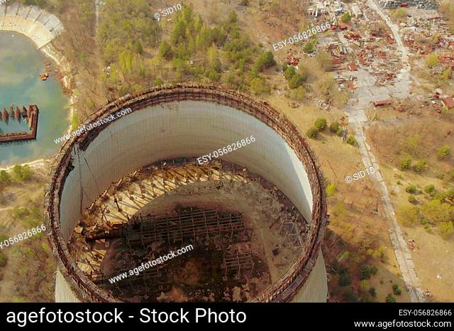 Flying over the cooling tower near the Chernobyl nuclear power plant. Territory near the Chernobyl NPP. Piles of metal and equipment contaminated by radiation...