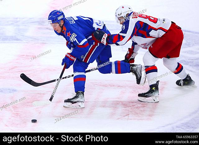 RUSSIA, ST PETERSBURG - DECEMBER 21, 2023: SKA's Vasily Glotov (L) and CSKA's Andrei Svetlakov fight for the puck in a 2023/24 KHL Regular Season ice hockey...