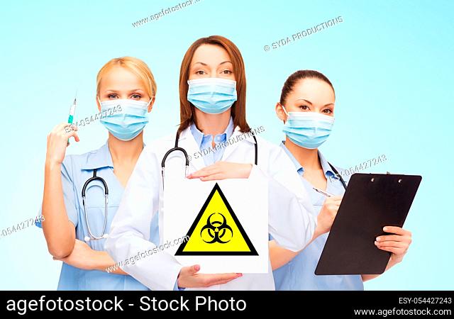 female doctor and nurses with biohazard sign