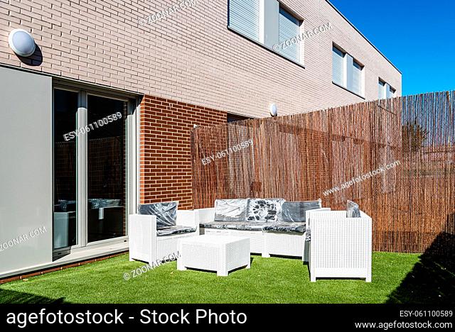 Garden of modern brick row houses in minimalistic shape. Outdoor shot on sunny day