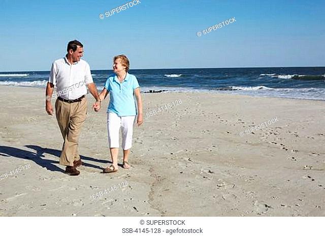 Couple walking on the beach, Far Rockaway, Queens, New York City, New York State, USA
