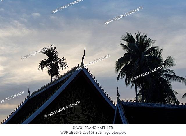 The silhouetted roof of Wat Wisunalat which is the oldest temple in the UNESCO world heritage town of Luang Prabang in Central Laos