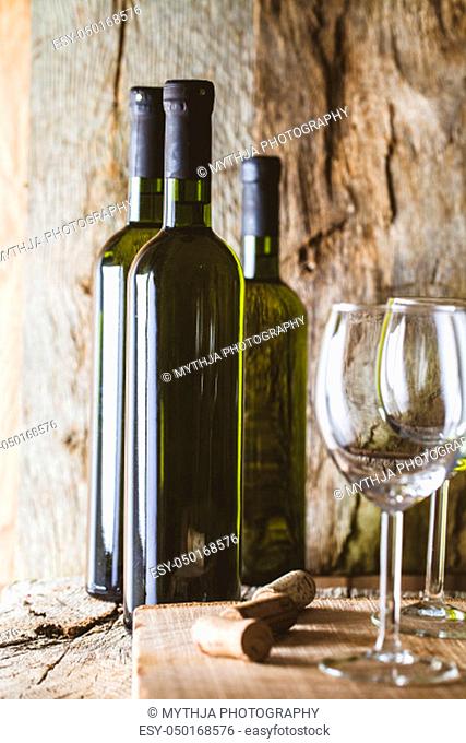 Wine. Glass of white wine in wine cellar. Old white wine on wood