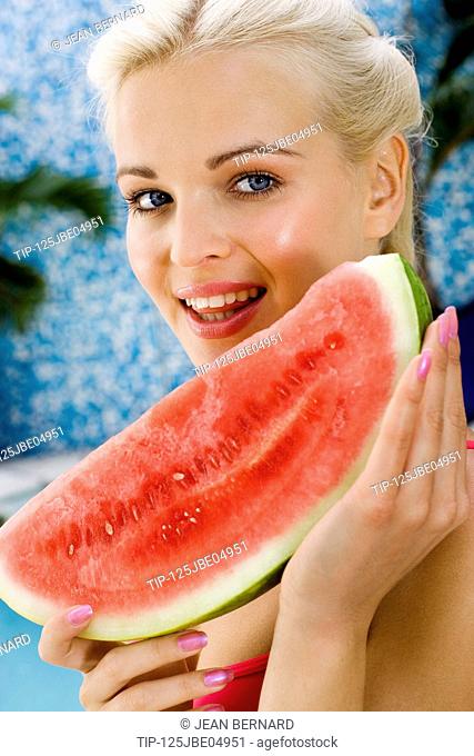 Woman's portrait with a slice of watermelon
