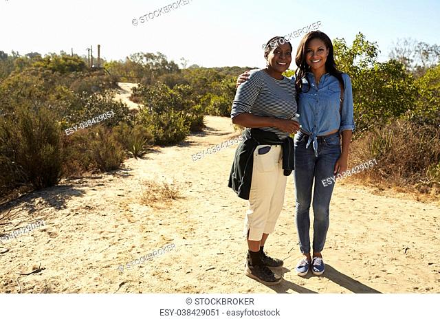 Portrait Of Mother And Adult Daughter Hiking In Countryside