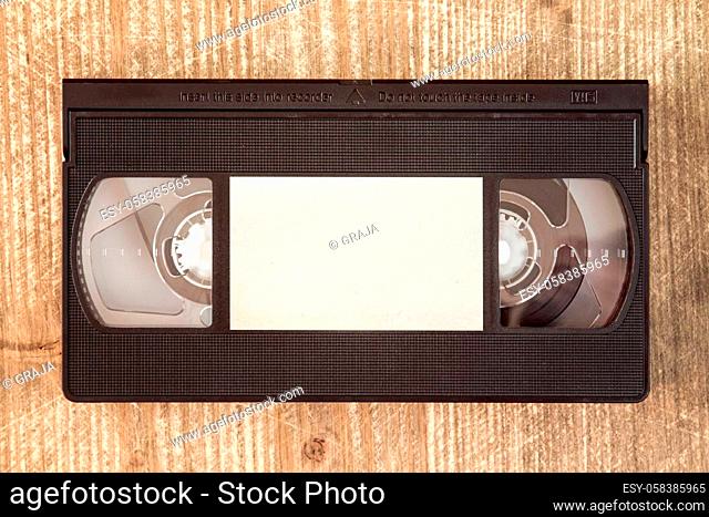 VHS video tape cassette on wooden background.Copy-space