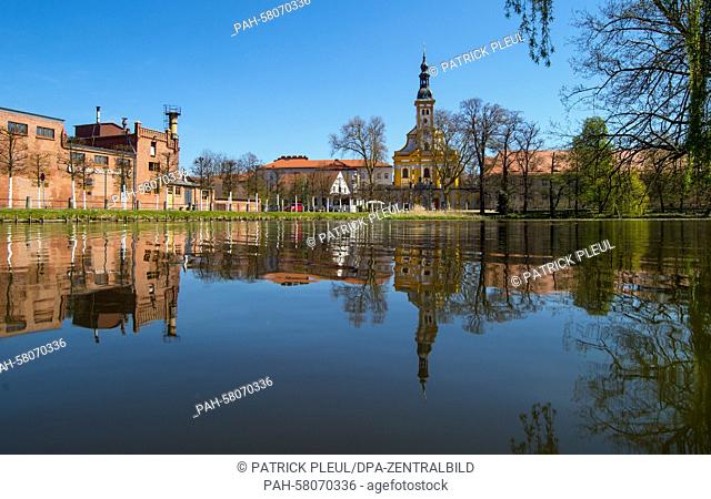 The Neuzelle Monastery and the Neuzelle Monastery Brewery are reflected in the water of a lake in the Oder-Spree district, Brandenburg, Germany, 23 April 2015