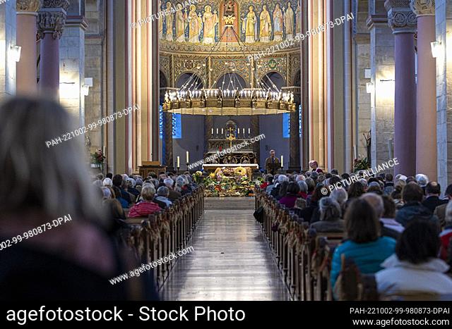 02 October 2022, Lower Saxony, Hildesheim: People sit in the Basilica of St. Godehard parish church at the Lower Saxony State Harvest Festival