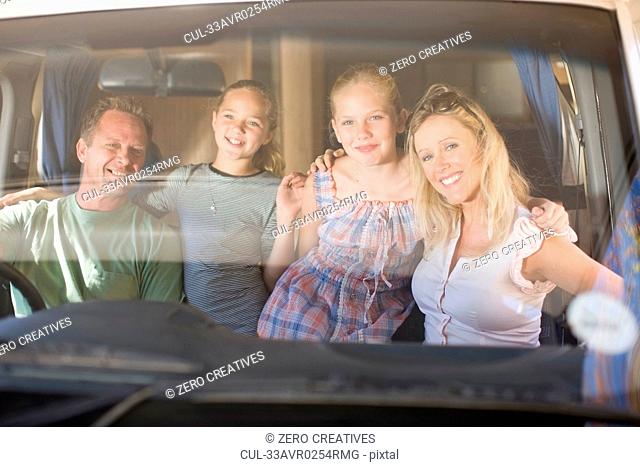 Family smiling together in RV
