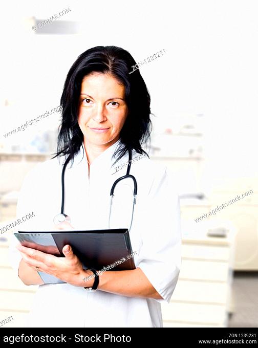 Attractive female doctor looks at the camera