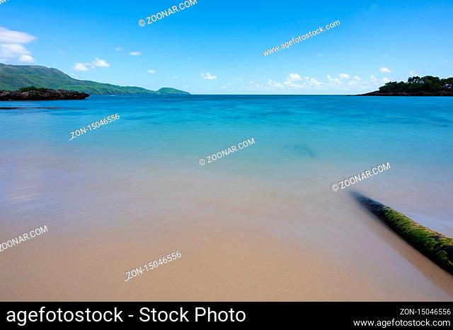 A view of exotic beach with sea, sand and blue sky, during the day on a public beach in Rincon Beach, Samana peninsula, Dominican Republic
