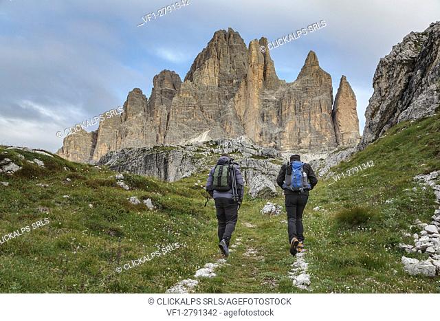 Europe, Italy, Veneto, Belluno. Hikers on a path near Tre Cime di Lavaredo south side, Dolomites