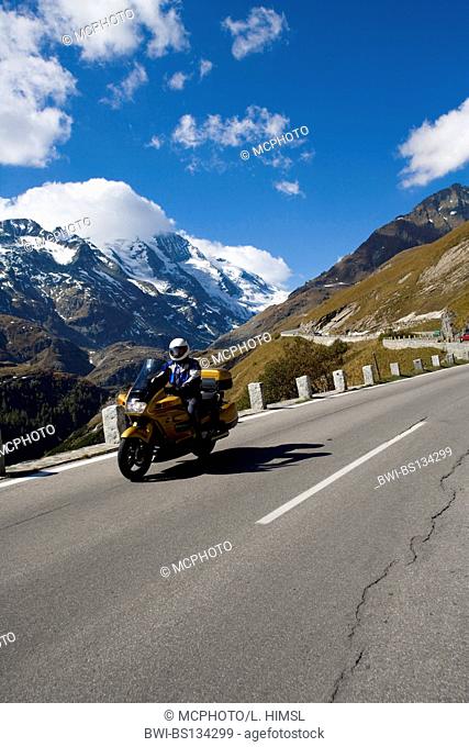 motorcyclist on high alpine road with the Grossglockner in the background, Austria