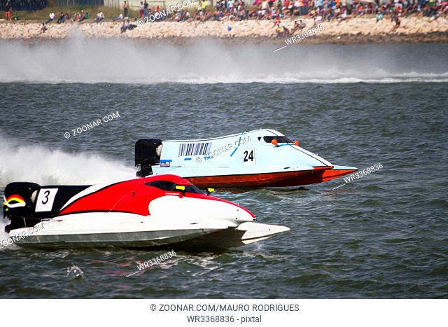 View of two powerboats racing on a lake in Portugal