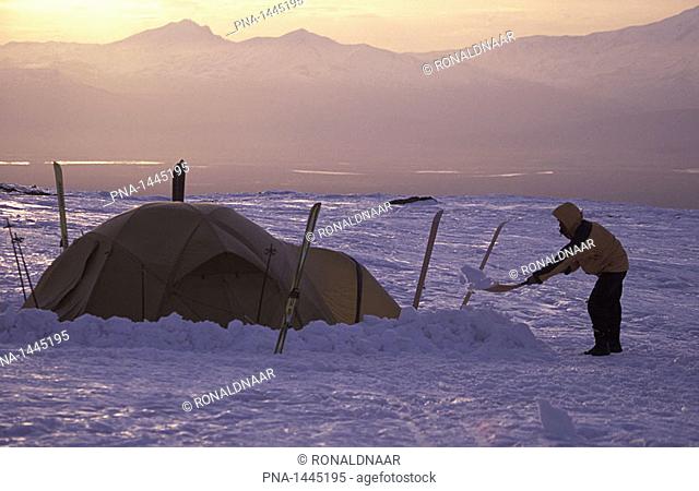 Building a campsite on the slopes of Klyuchevskaya sopka, Kamchatka, Russia  In the background: Kamtchaka river