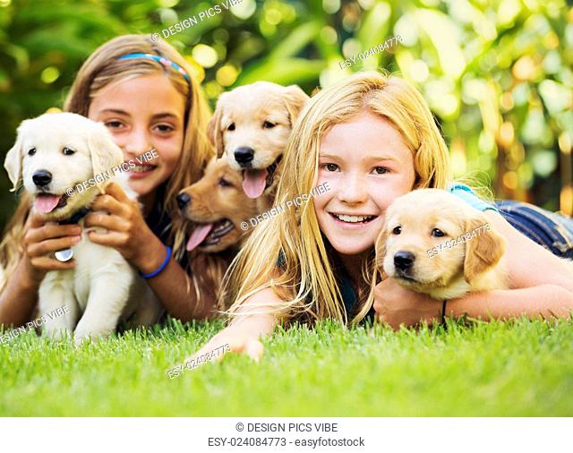Adorable Cute Young Girls with Puppies