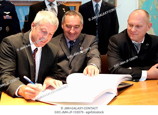 At the Gagarin Cosmonaut Training Center in Star City, Russia, Expedition 3738 backup Flight Engineer Steve Swanson of NASA (left) signs a certification book in...