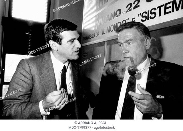 Italian labour leader and politician Giorgio Benvenuto talking to Italian labour leader and politician Bruno Trentin with a pipe in his mouth. 1980s