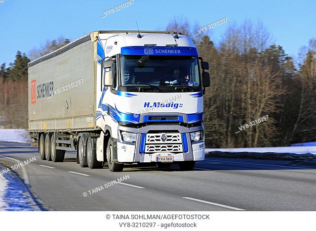 Salo, Finland - March 2, 2018: Blue and white Renault Trucks T of Helmer Modig Oy pulls DB Schenker trailer on road at speed on sunny day of winter
