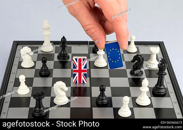 Hand policy raises the figure with the flag of the European Union. The concept of political game and chess strategy Brexit