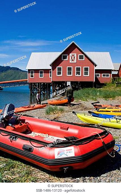 Inflatable raft on the coast with a museum in the background, Glacier Bay, Cannery Museum, Icy Strait Point, Hoonah City, Chichagof Island, Alaska, USA