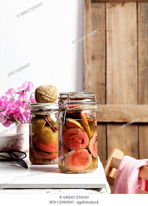 Spiced preserved guavas in a preserving jar